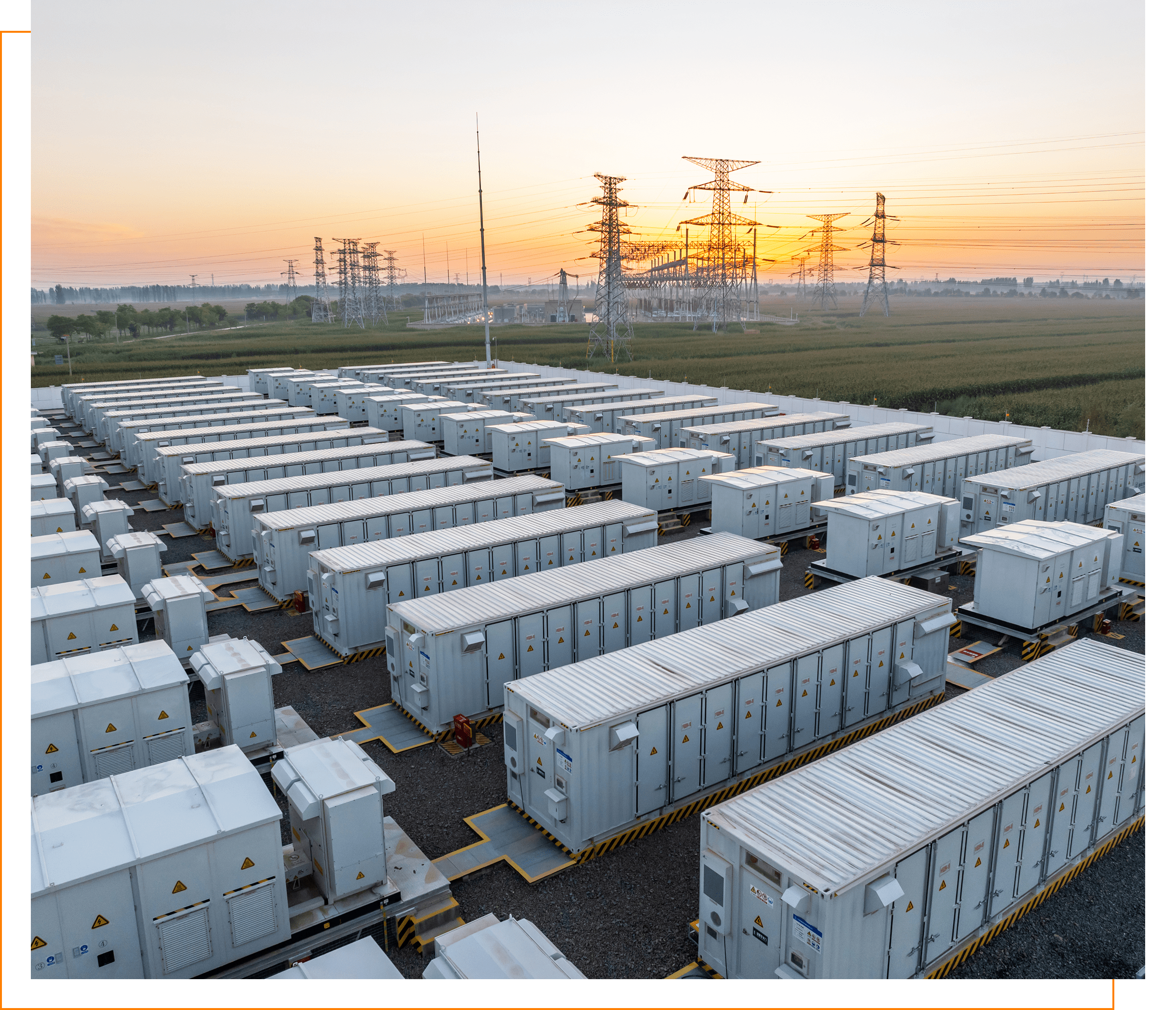 Industrial battery storage units at sunrise